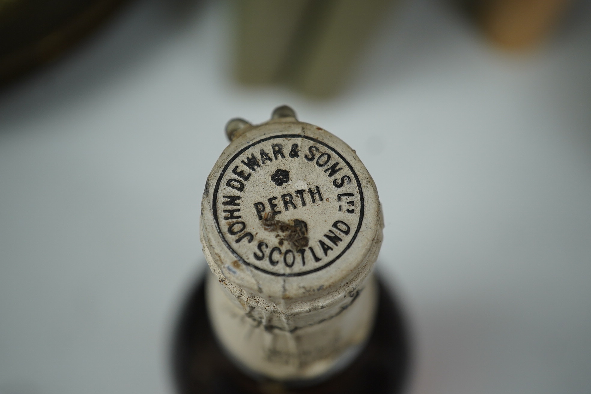 John Dewar & Sons Ltd. White Label, Finest Scotch Whisky Of Great Age, By Appointment to Her Majesty The Queen. Condition - label stained, bottle dirty, sealed